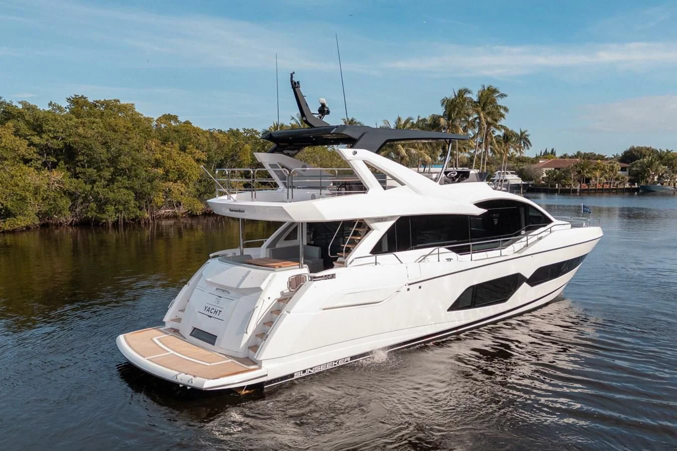 a white boat in a body of water aboard 76 YACHT Yacht for Sale
