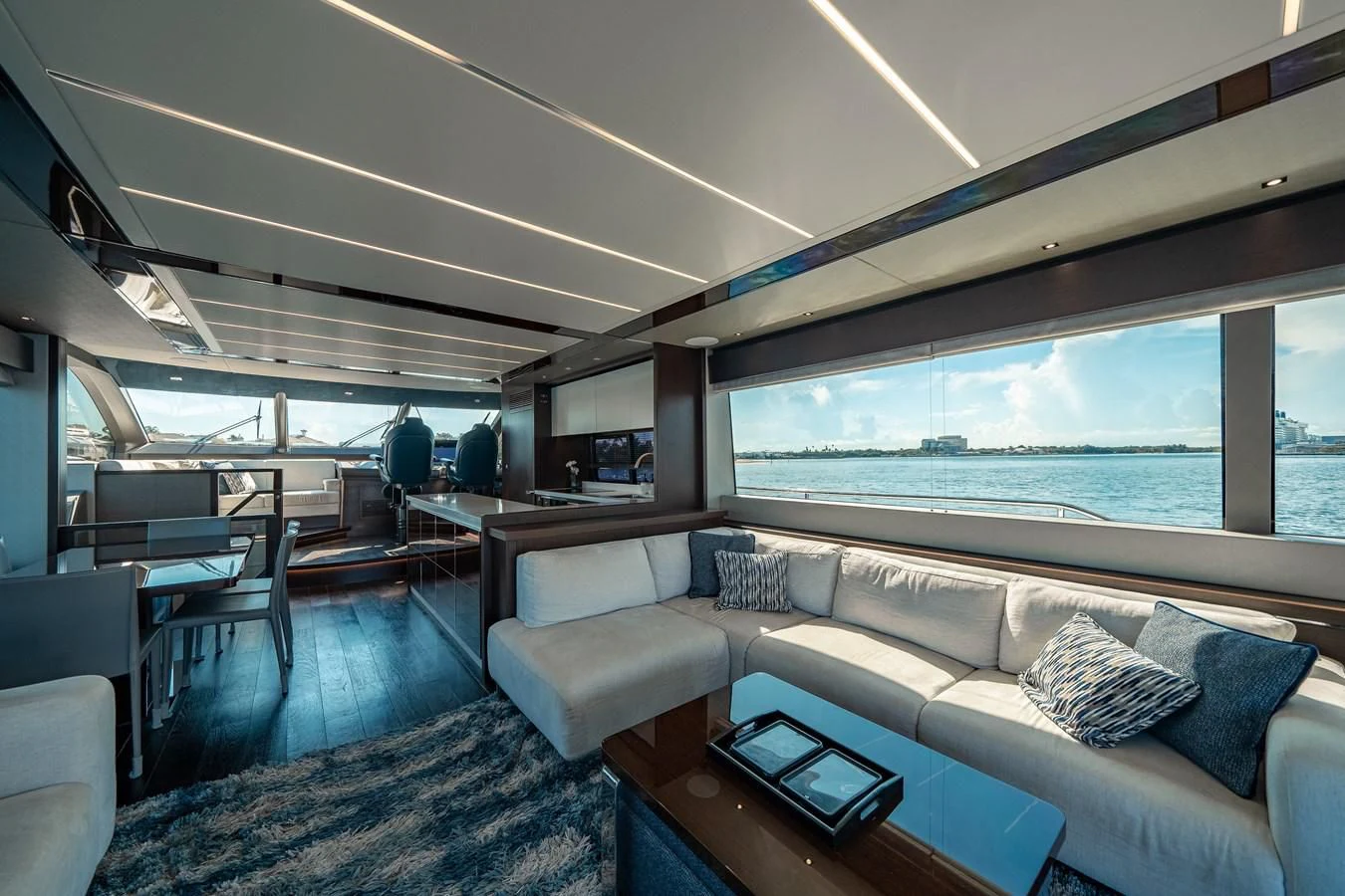 a room with a couch and a table and a large window aboard 76 YACHT Yacht for Sale
