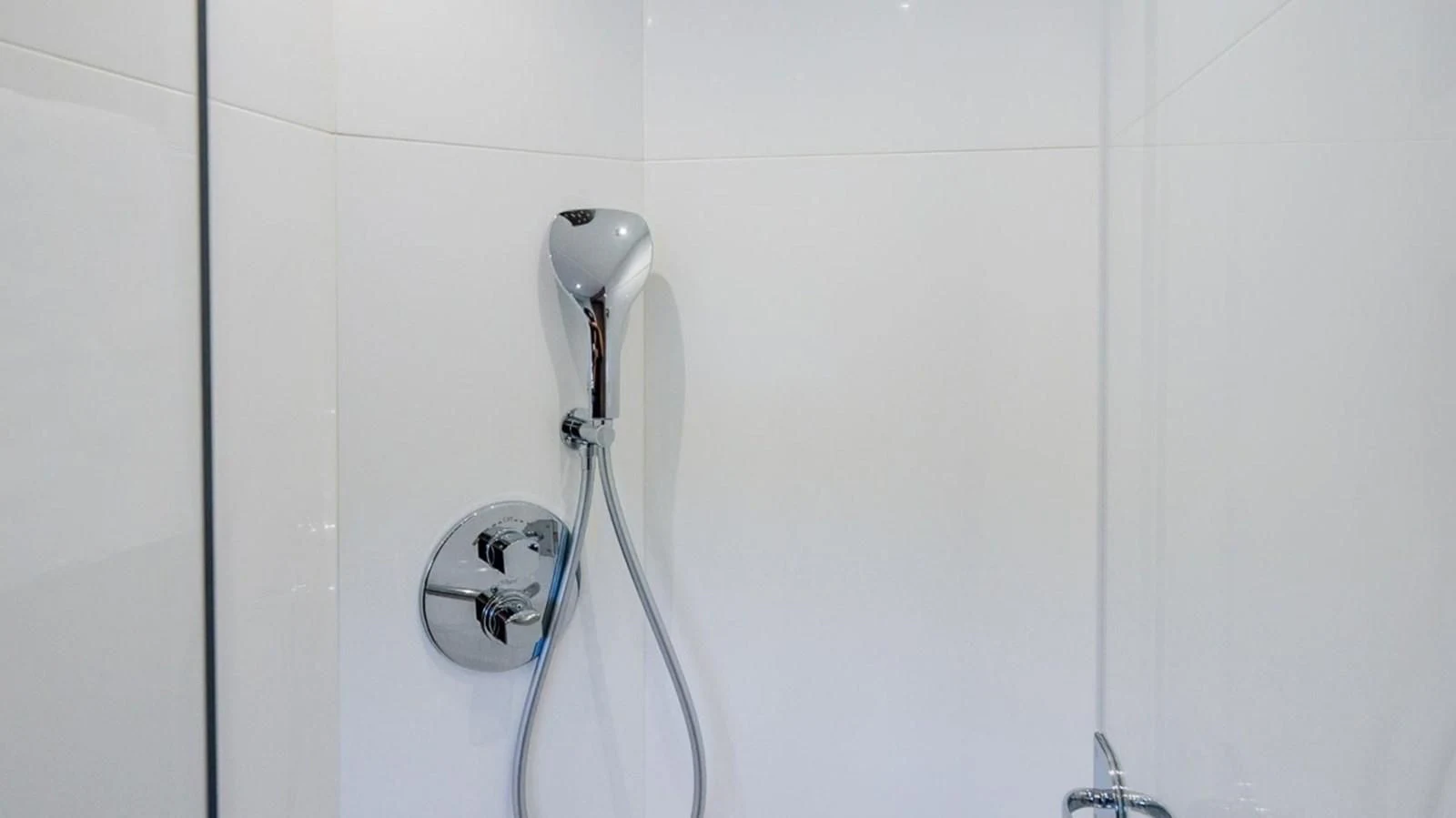 a shower head in a white tiled room aboard 76 YACHT Yacht for Sale