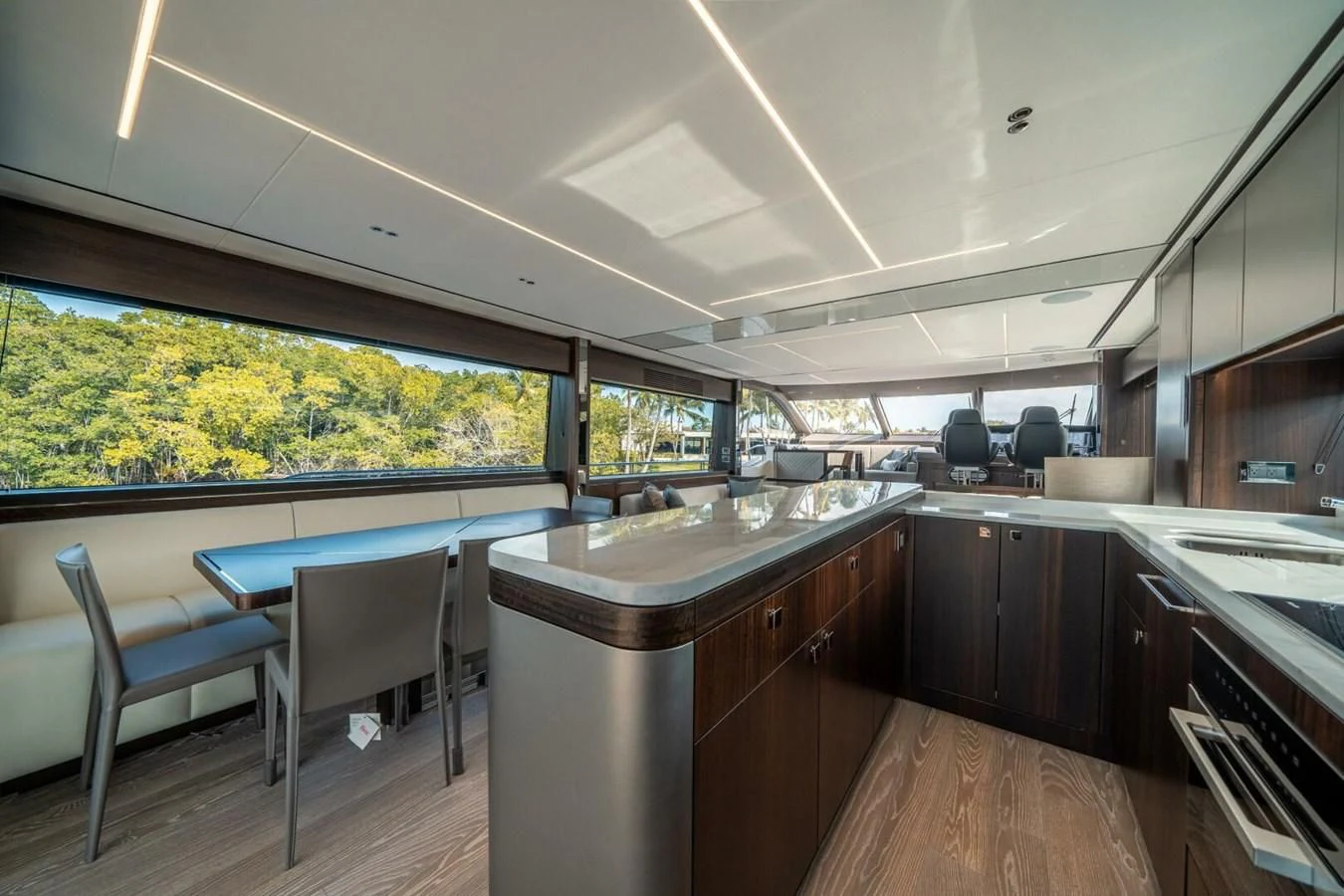 a kitchen with a bar and a table and chairs aboard 76 YACHT Yacht for Sale
