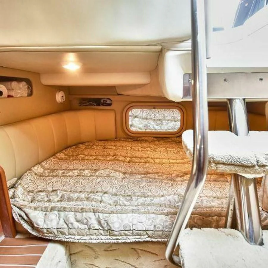 a small bed with a white comforter and a white bed aboard 76 YACHT Yacht for Sale