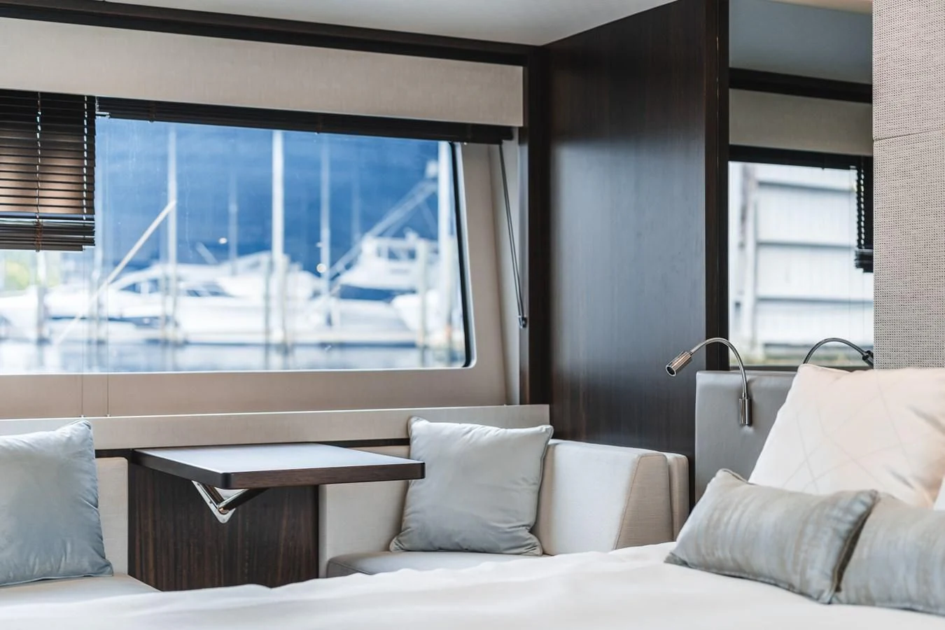 a bed with pillows and a window aboard 76 YACHT Yacht for Sale