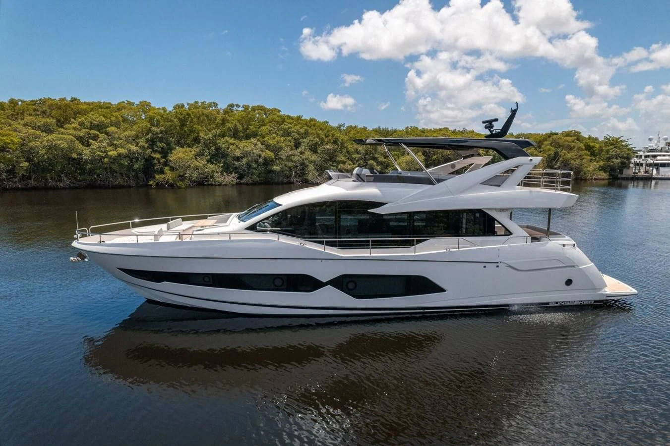 a white boat on a lake aboard 76 YACHT Yacht for Sale
