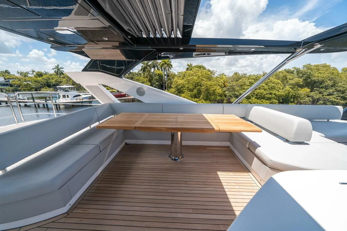 a deck with a table and chairs aboard 76 YACHT Yacht for Sale