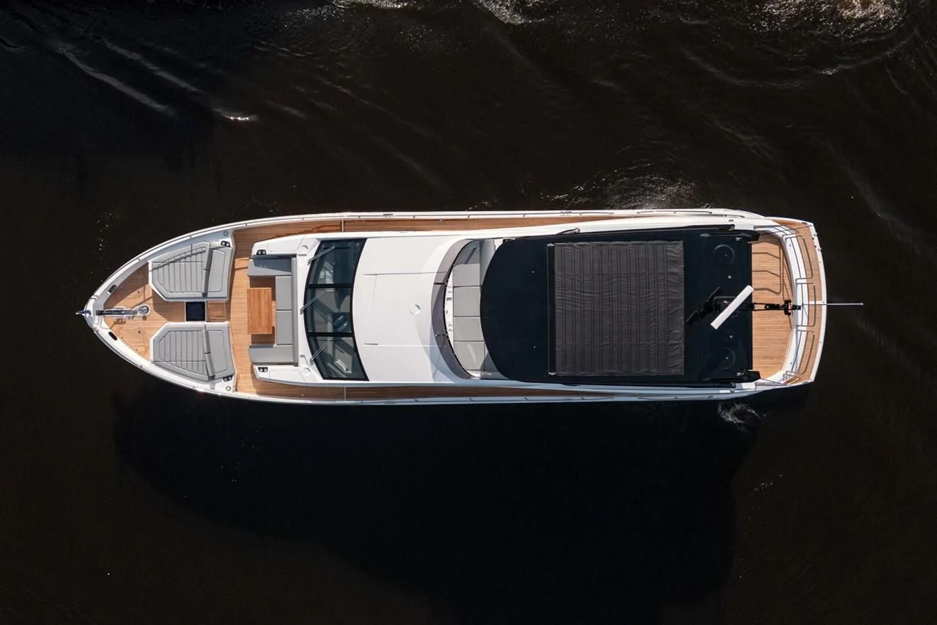 a small white car with a black door and a black background aboard 76 YACHT Yacht for Sale