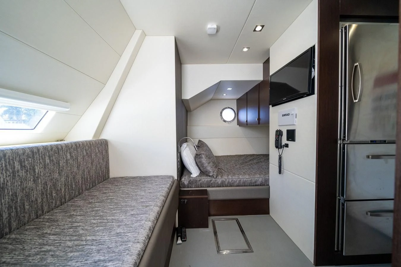 a kitchen with a couch and a refrigerator aboard 76 YACHT Yacht for Sale