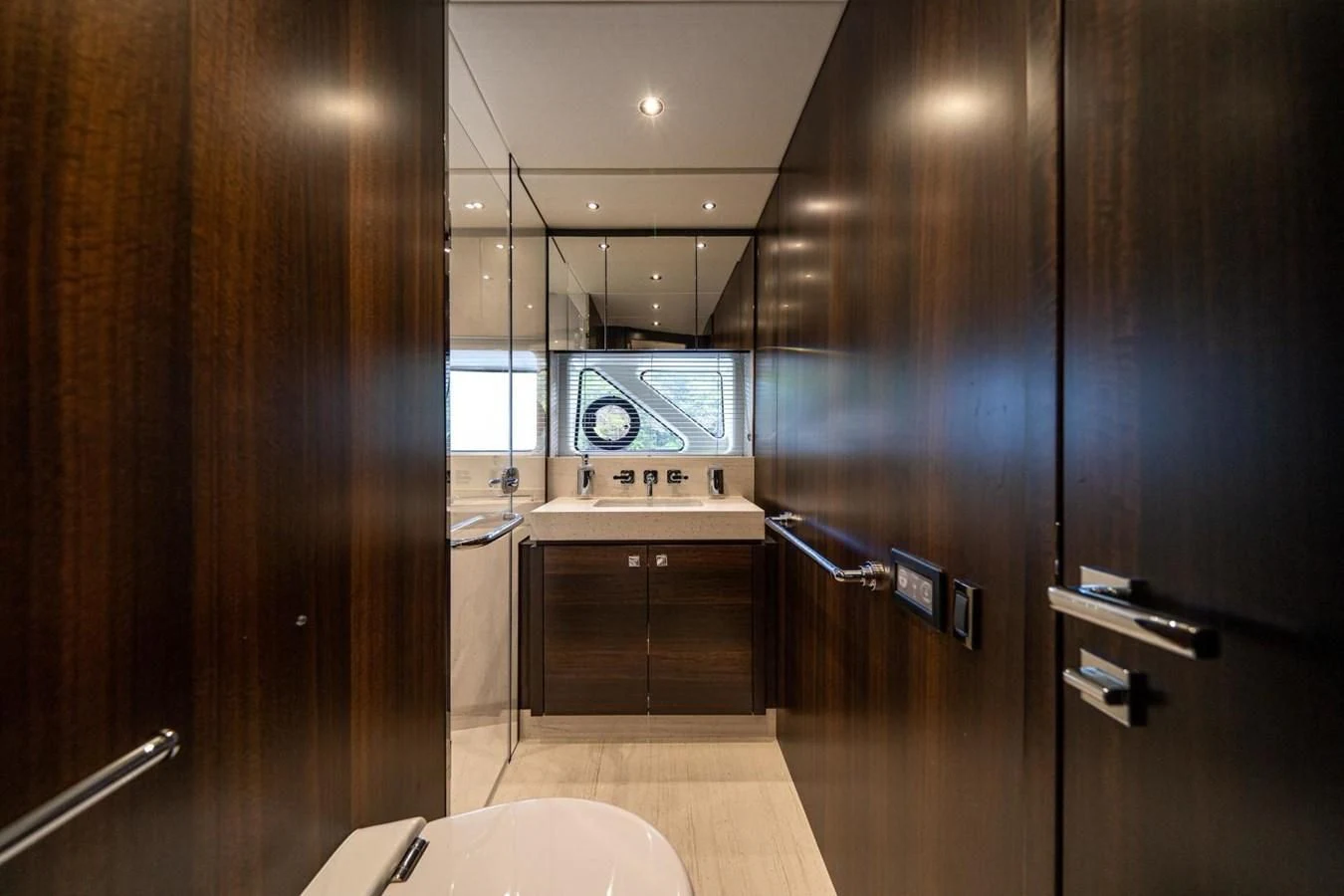 a bathroom with a sink and a refrigerator aboard 76 YACHT Yacht for Sale