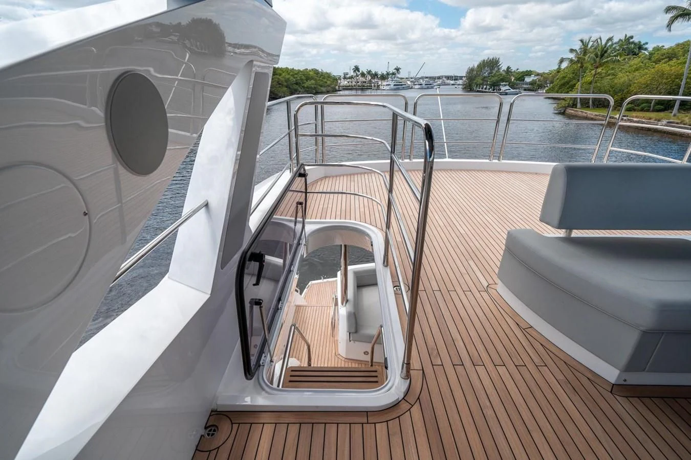 a deck with a deck and a railing with a body of water in the background aboard 76 YACHT Yacht for Sale