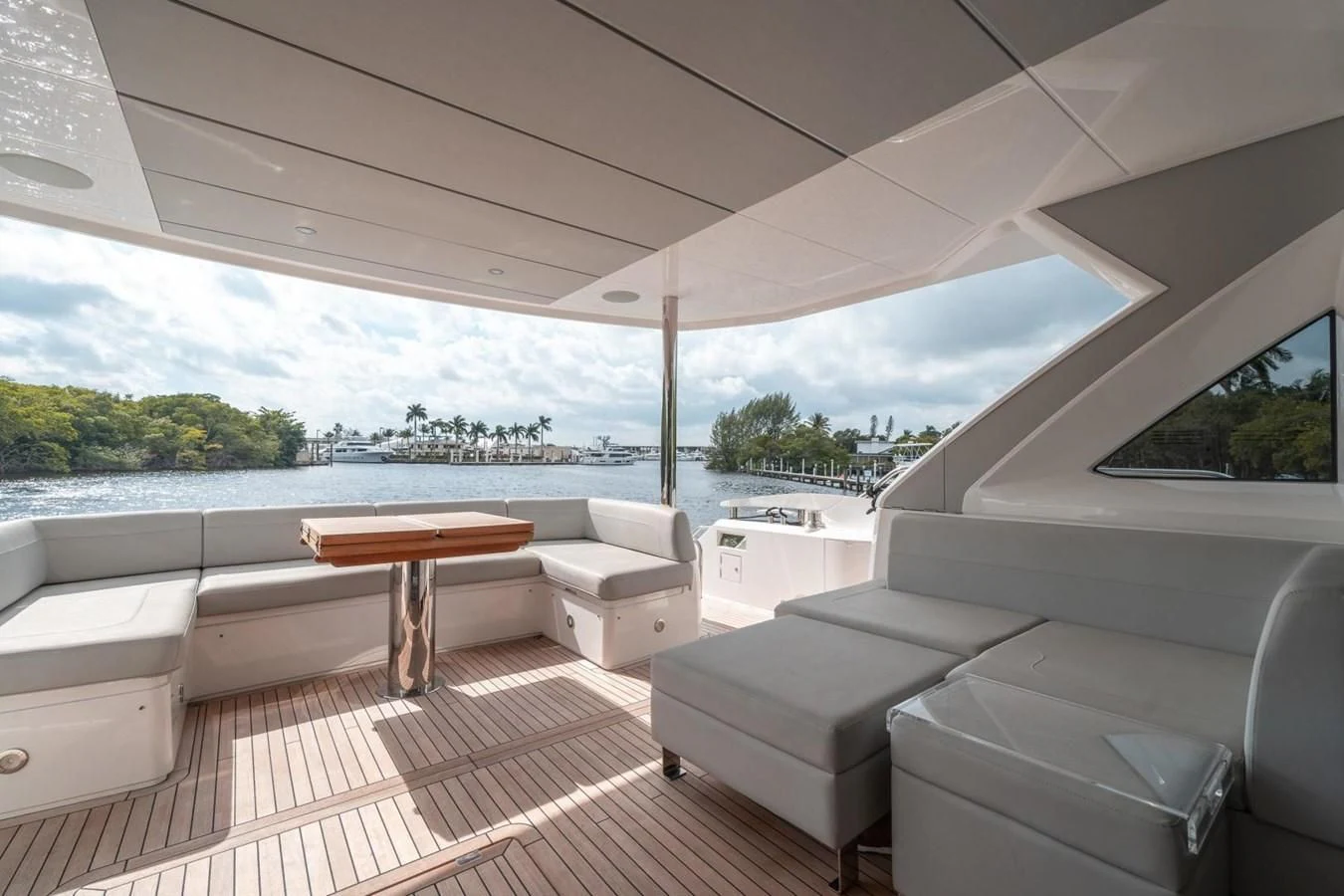 a room with a couch and a table and a view of the water aboard 76 YACHT Yacht for Sale
