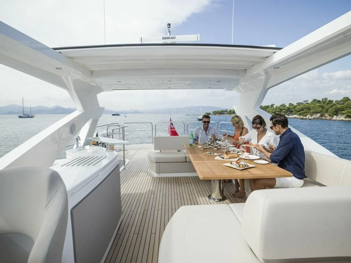 a group of people sitting around a table on a boat aboard 76 YACHT Yacht for Sale