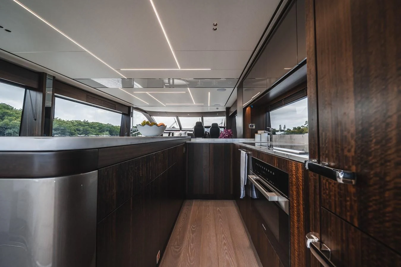 a kitchen with wooden cabinets aboard 76 YACHT Yacht for Sale