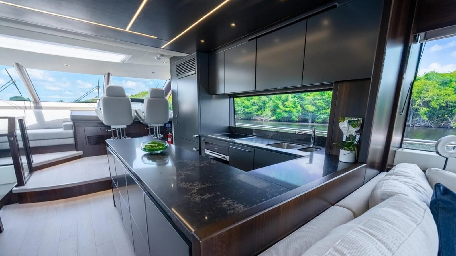 a modern looking kitchen with a large island aboard 76 YACHT Yacht for Sale