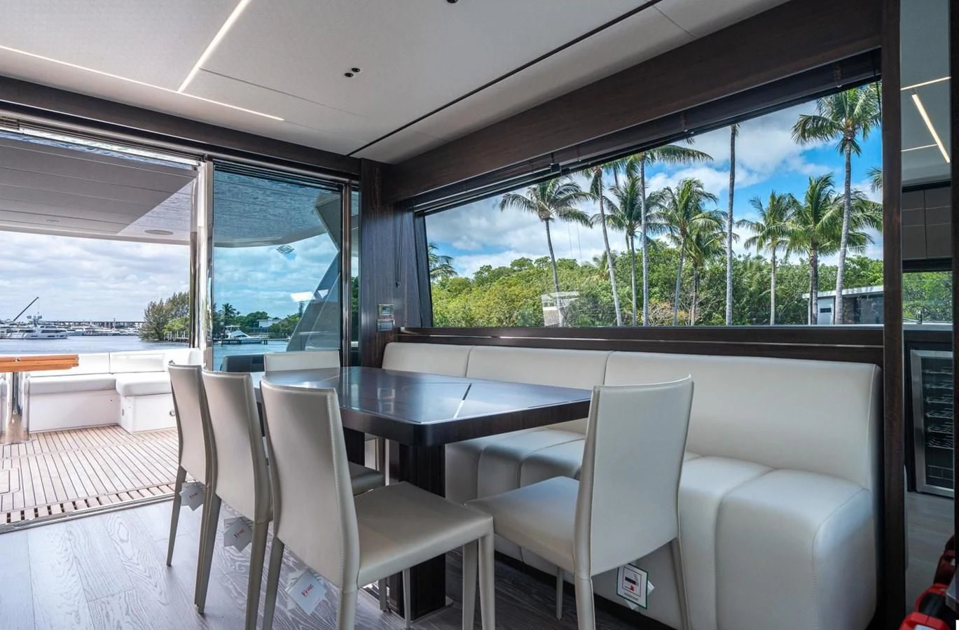 a room with a table chairs and a large window aboard 76 YACHT Yacht for Sale