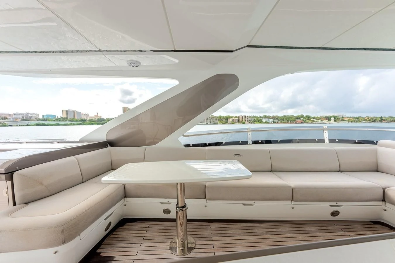 a white couch with a table in front of a window aboard 76 YACHT Yacht for Sale
