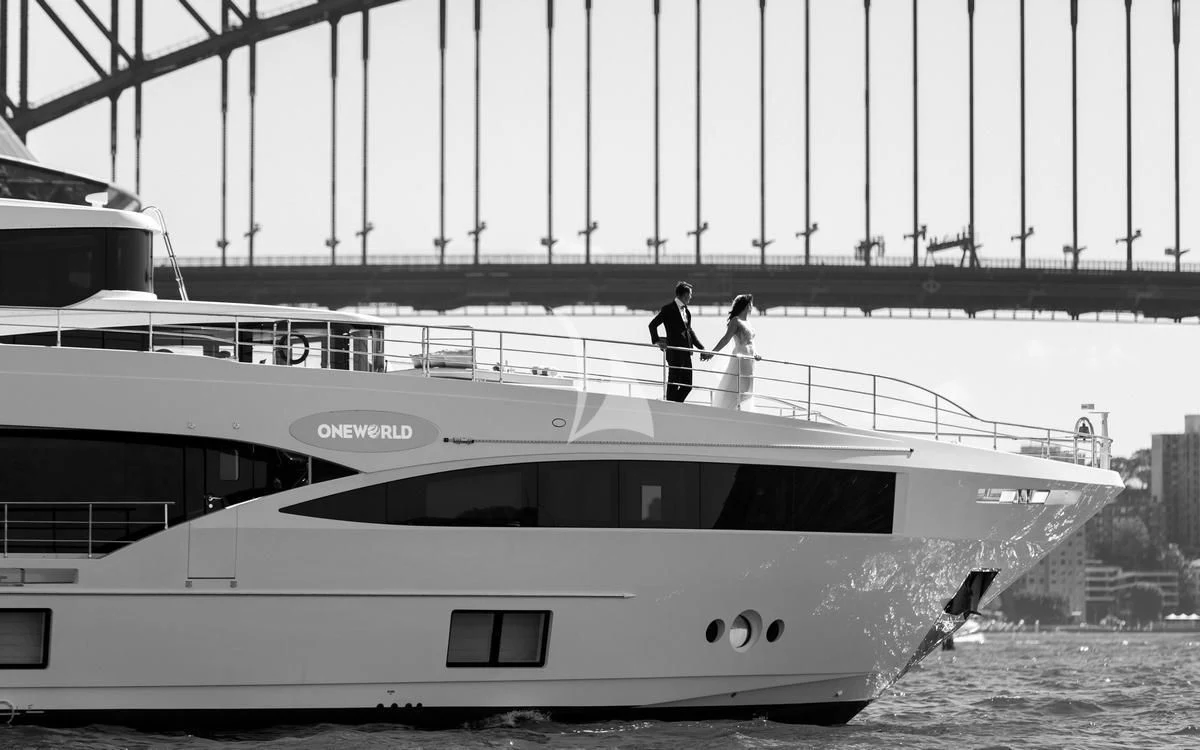 a couple of people walking on a boat aboard ONEWORLD Yacht for Sale