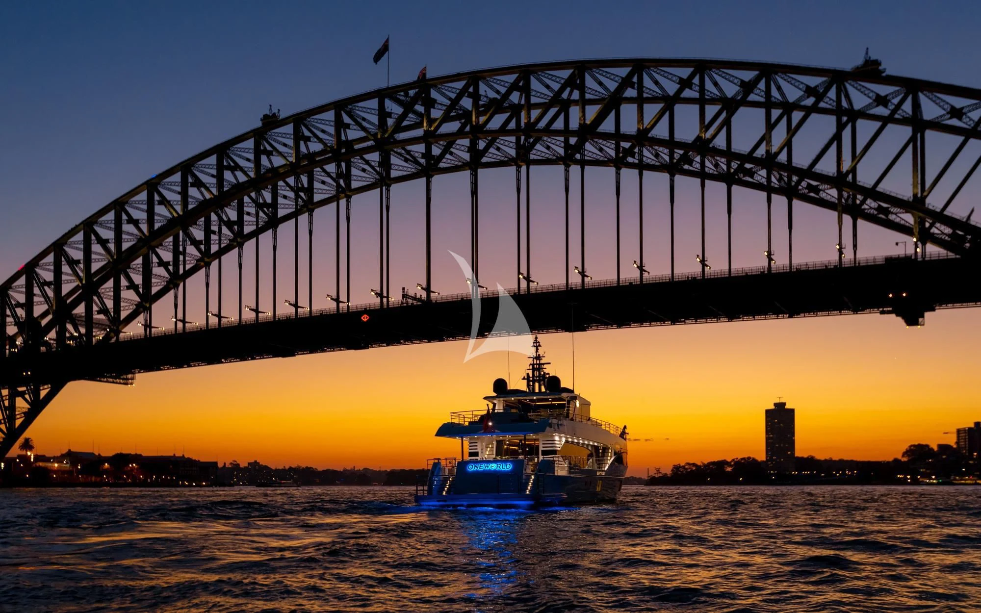 a boat sailing under a bridge aboard ONEWORLD Yacht for Sale