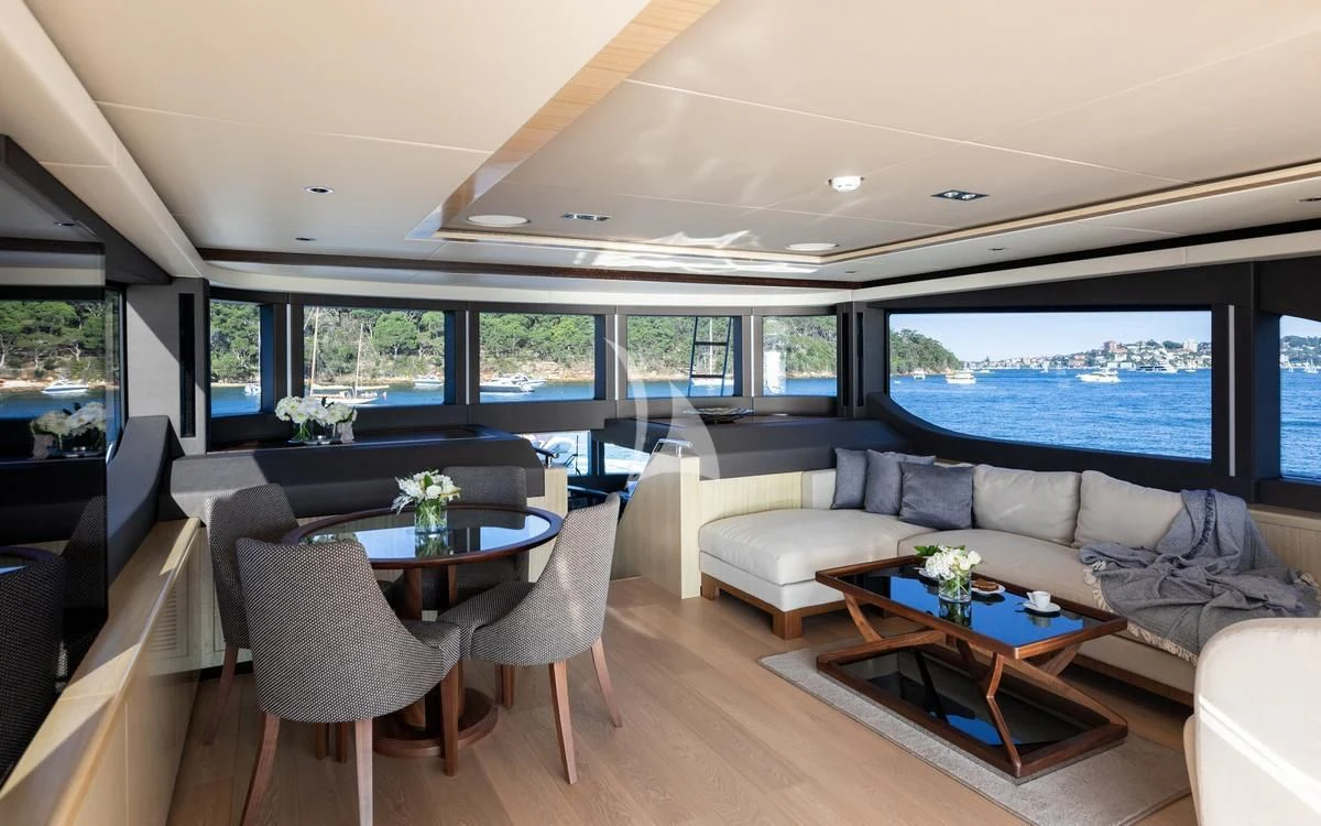 a living room with a large window aboard ONEWORLD Yacht for Sale