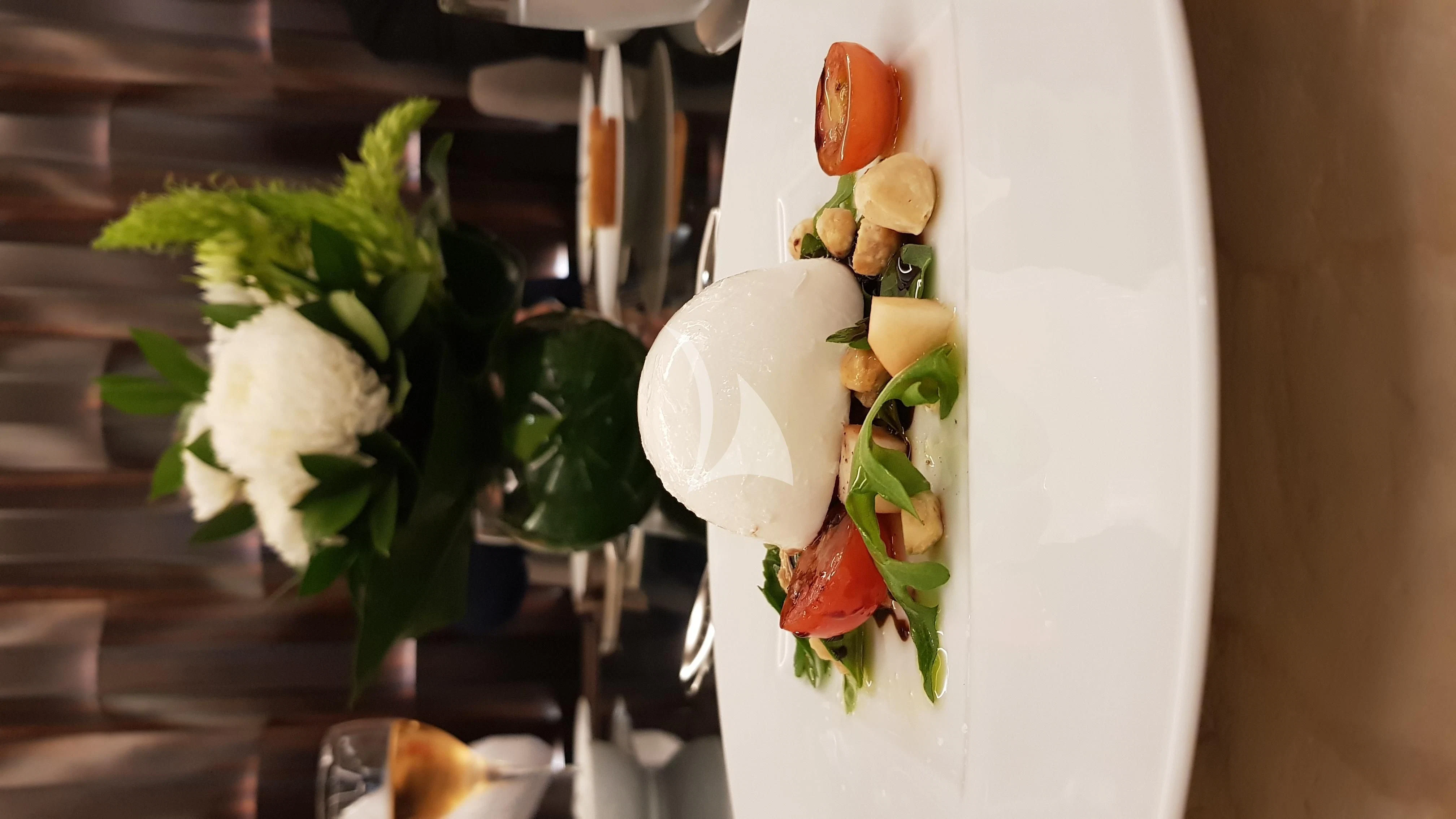 a white flower in a vase aboard ONEWORLD Yacht for Sale