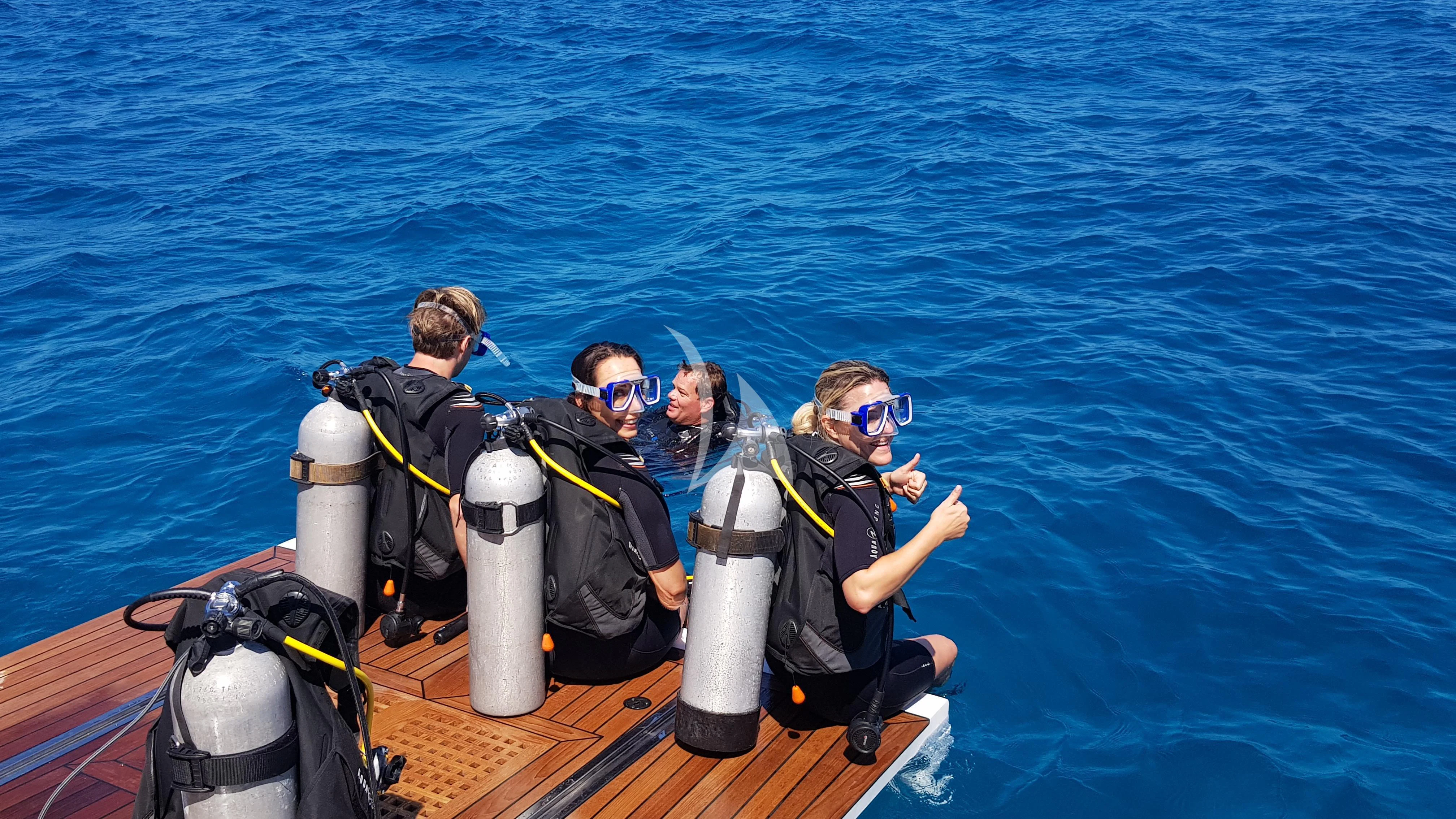 a group of people in a boat aboard ONEWORLD Yacht for Sale