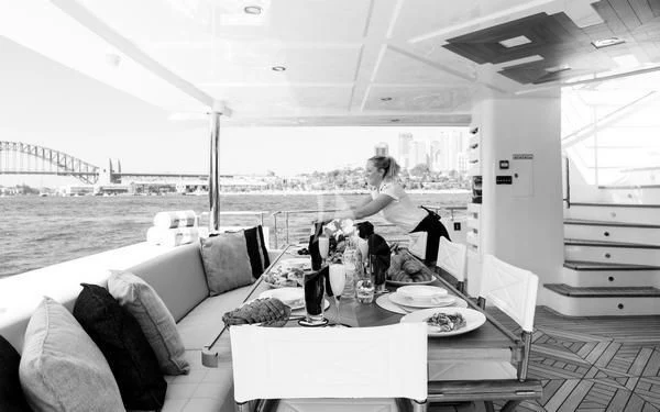 a person sitting on a couch aboard ONEWORLD Yacht for Sale