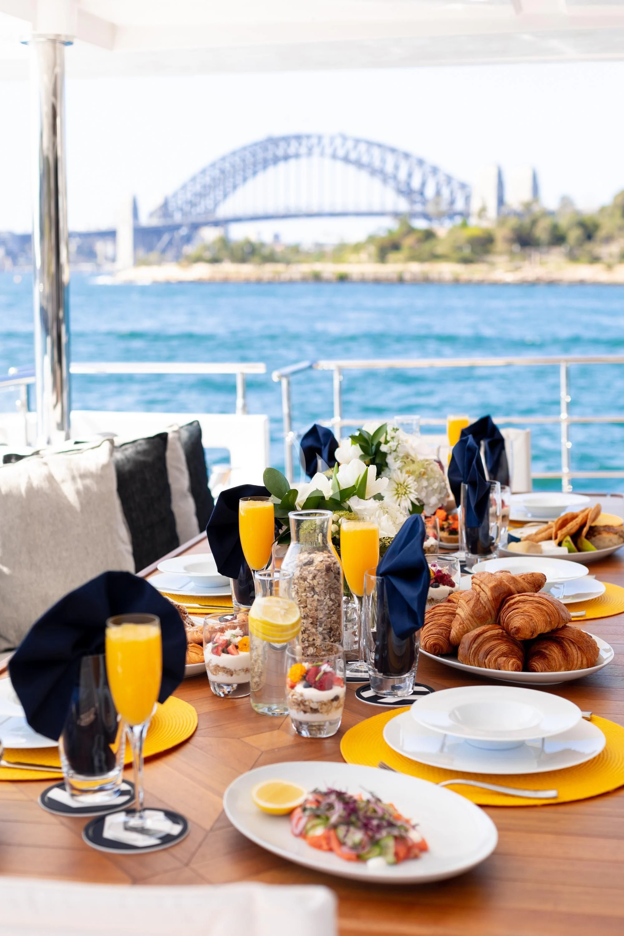 a table with food and drinks on it aboard ONEWORLD Yacht for Sale
