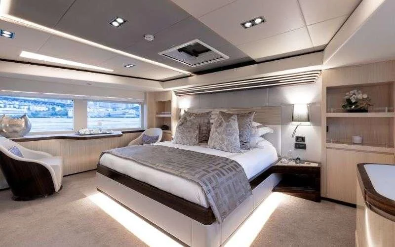 a bedroom with a large bed aboard ONEWORLD Yacht for Sale