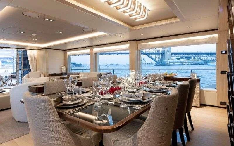 a dining table set for a meal aboard ONEWORLD Yacht for Sale