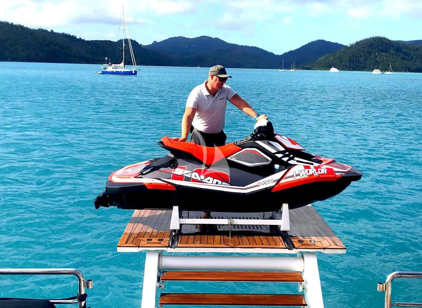 a person standing on a dock with a boat on it aboard ONEWORLD Yacht for Sale