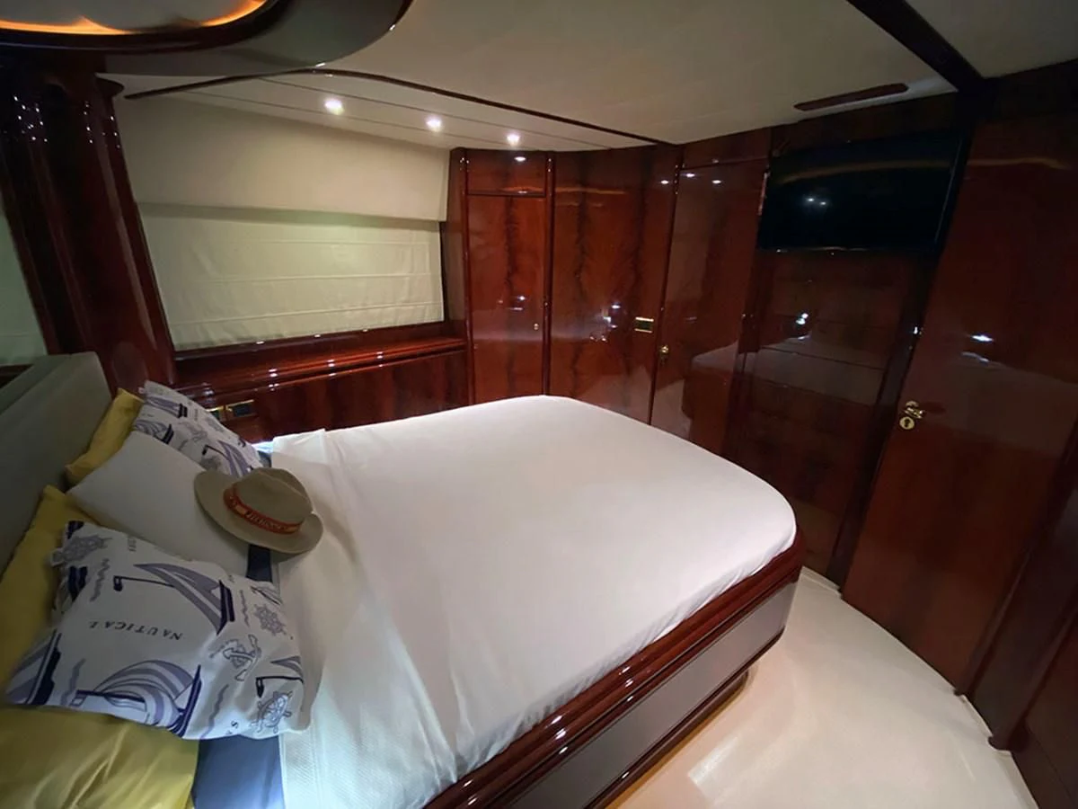 a bed with a white sheet and pillows on it aboard SPEED 5 Yacht for Sale