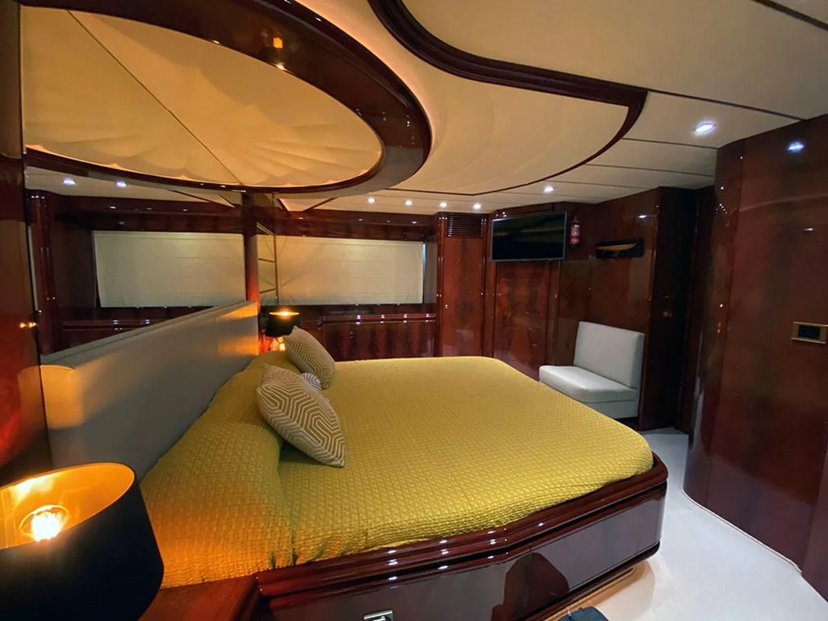 a room with a bed and a chair aboard SPEED 5 Yacht for Sale