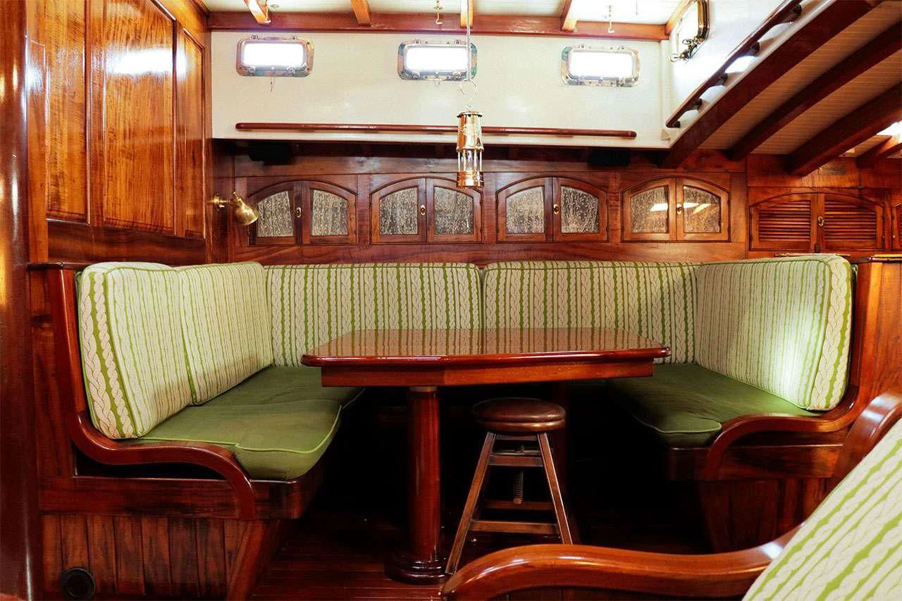 a room with a table and stools aboard TREE OF LIFE Yacht for Sale