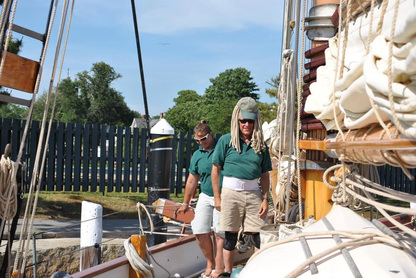 a man and woman standing next to a boat aboard TREE OF LIFE Yacht for Sale