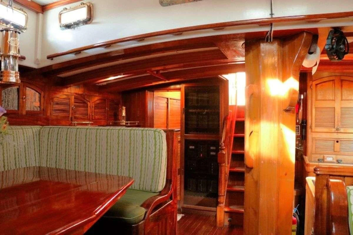 a room with a table and chairs aboard TREE OF LIFE Yacht for Sale