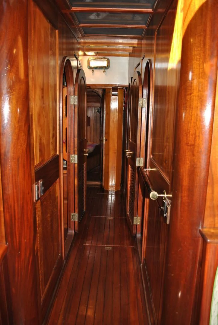a hallway with wooden doors aboard TREE OF LIFE Yacht for Sale
