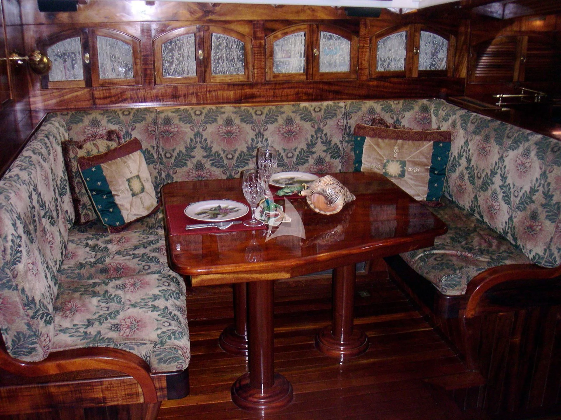 a table with plates and glasses on it aboard TREE OF LIFE Yacht for Sale