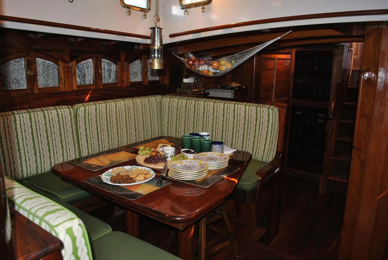 a table with plates of food on it aboard TREE OF LIFE Yacht for Sale