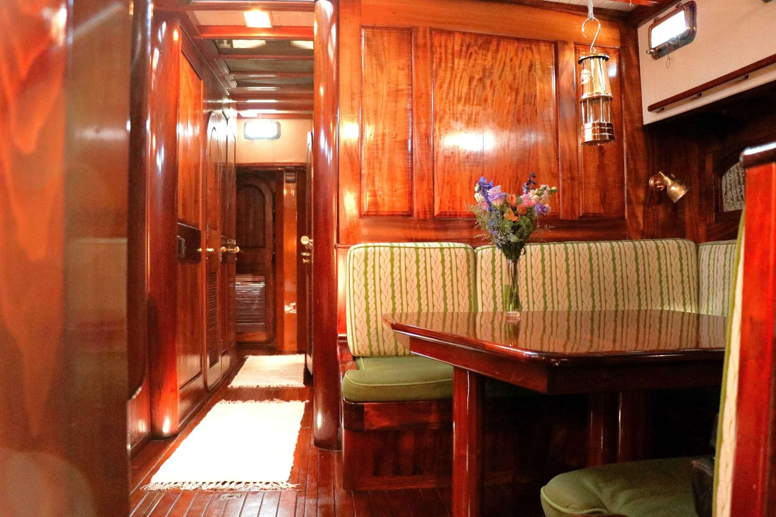 a room with a table and chairs aboard TREE OF LIFE Yacht for Sale