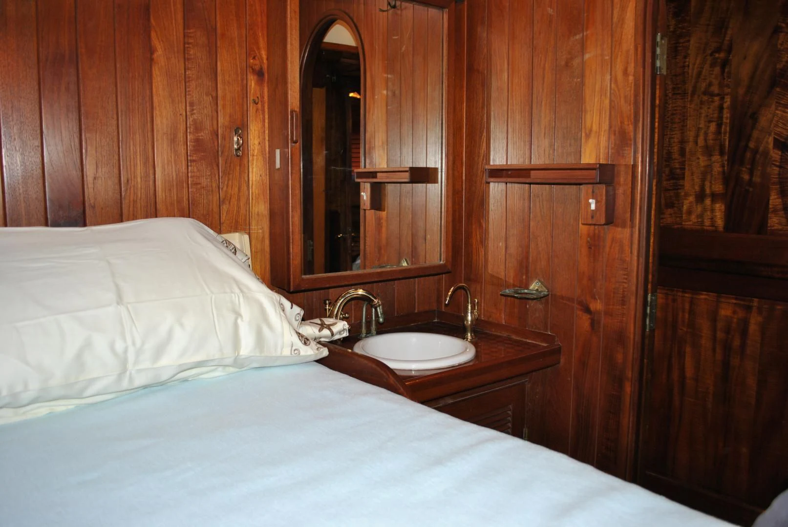 a bed with a sink and a mirror aboard TREE OF LIFE Yacht for Sale