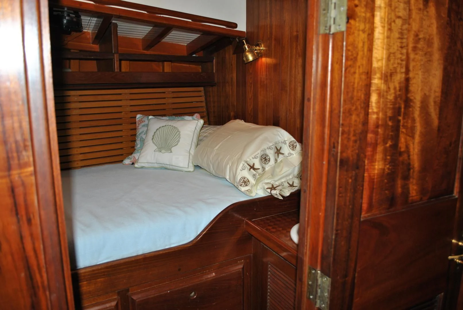 a bed with white sheets aboard TREE OF LIFE Yacht for Sale