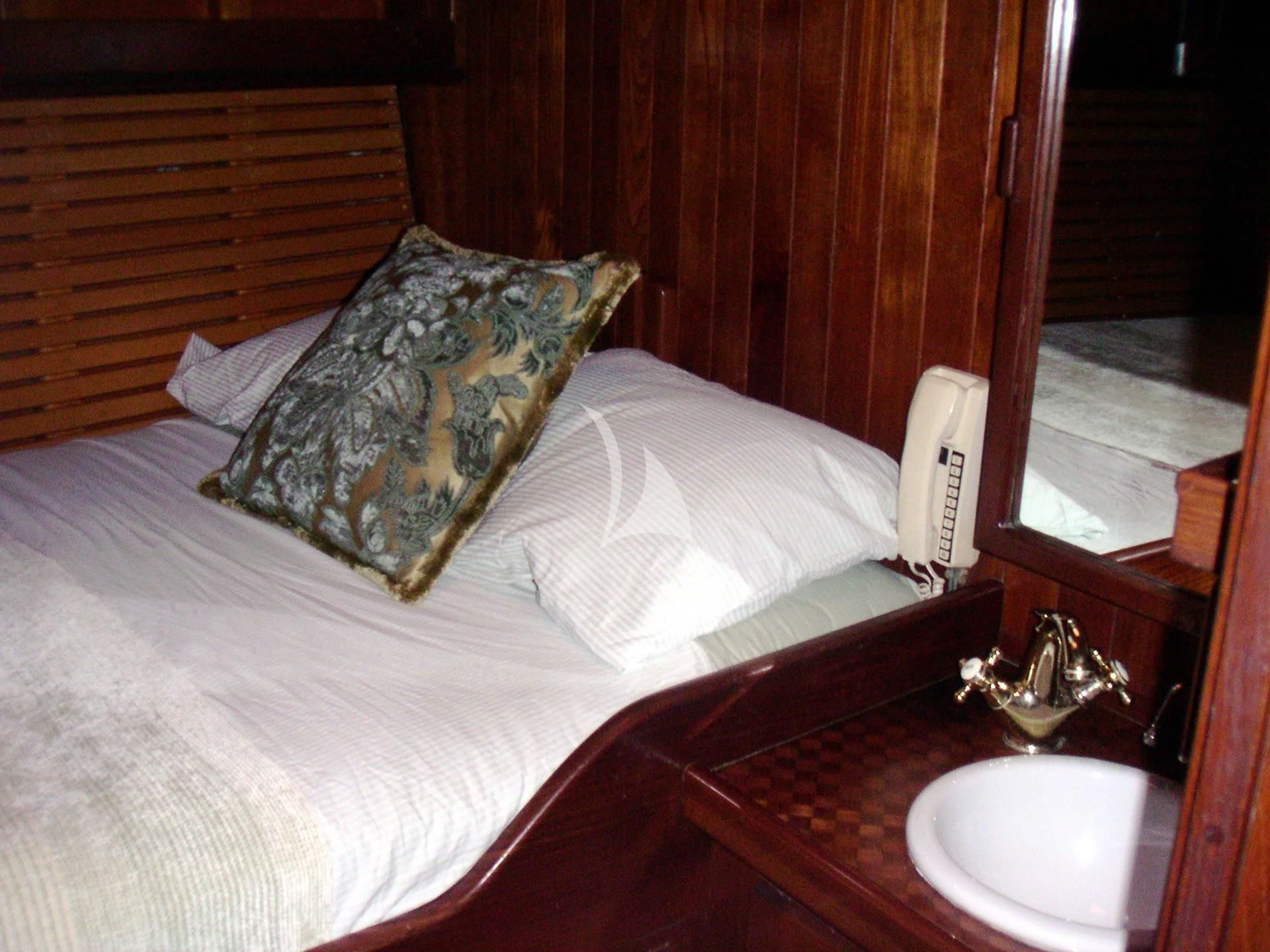 a bed with a pillow and a phone on it aboard TREE OF LIFE Yacht for Sale