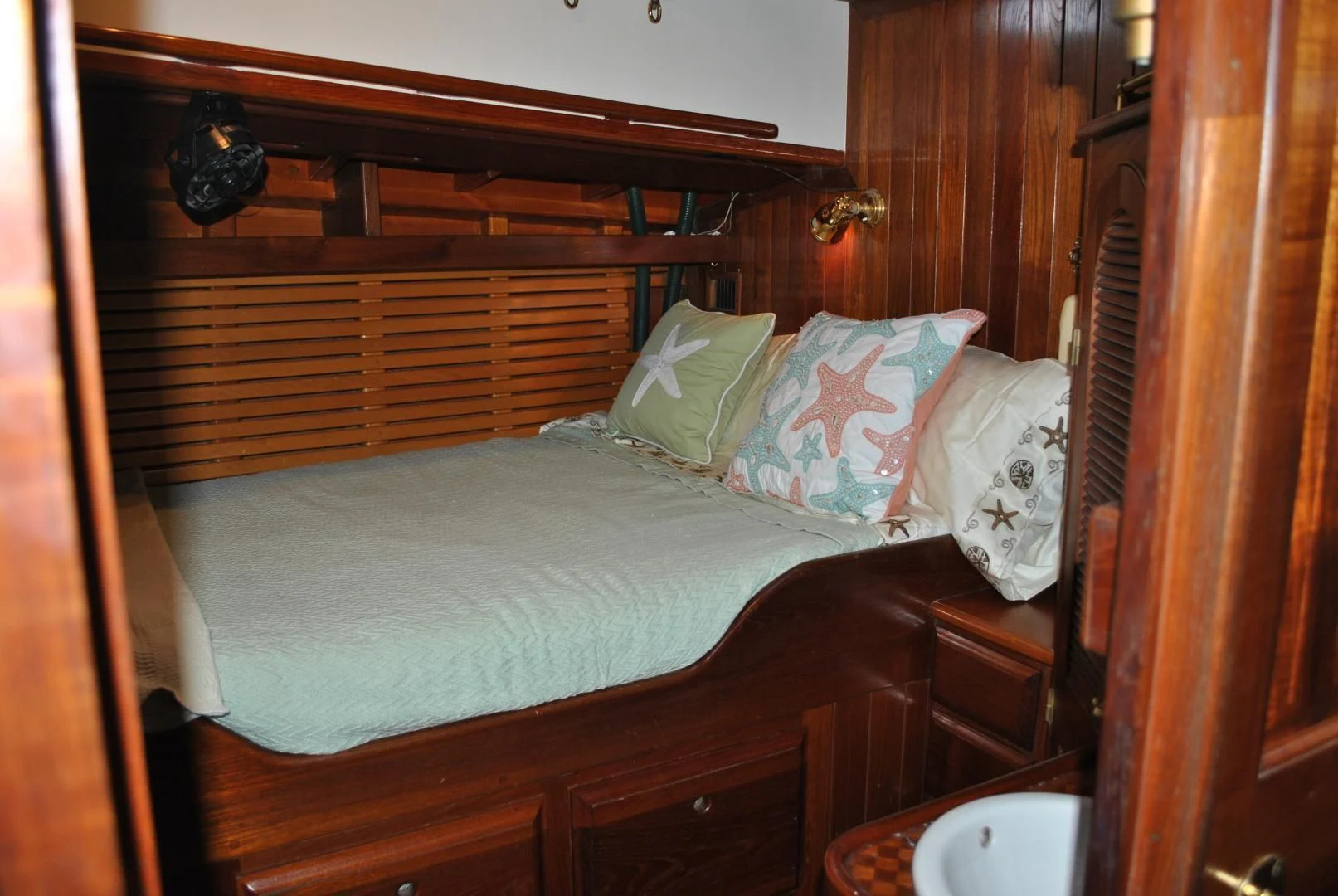 a bed with white sheets and pillows aboard TREE OF LIFE Yacht for Sale