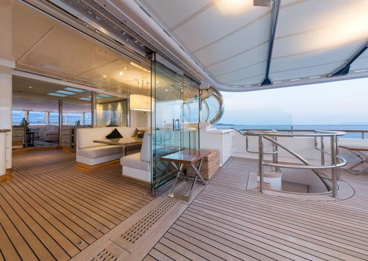 a room with a wood floor and a table and chairs aboard ZEUS Yacht for Sale