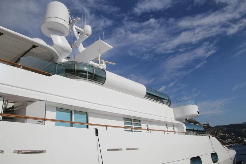 a white boat with a satellite dish on top aboard ZEUS Yacht for Sale