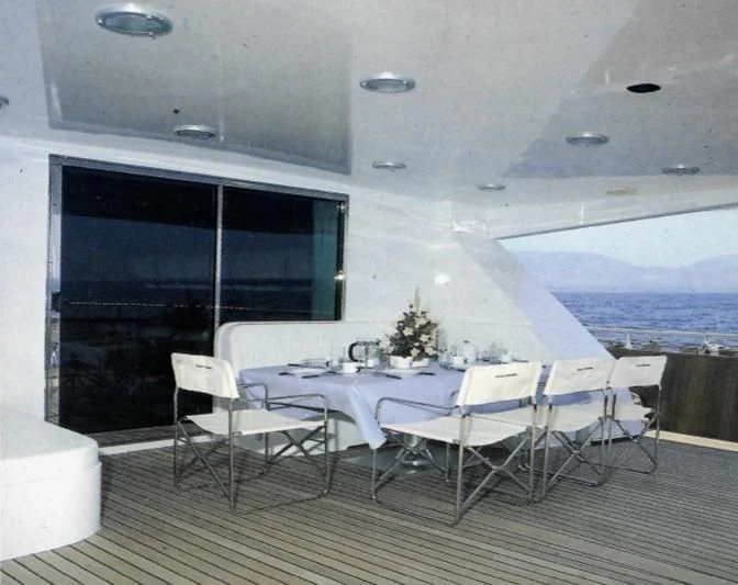 a room with tables and chairs aboard SOMETHING WILD Yacht for Sale