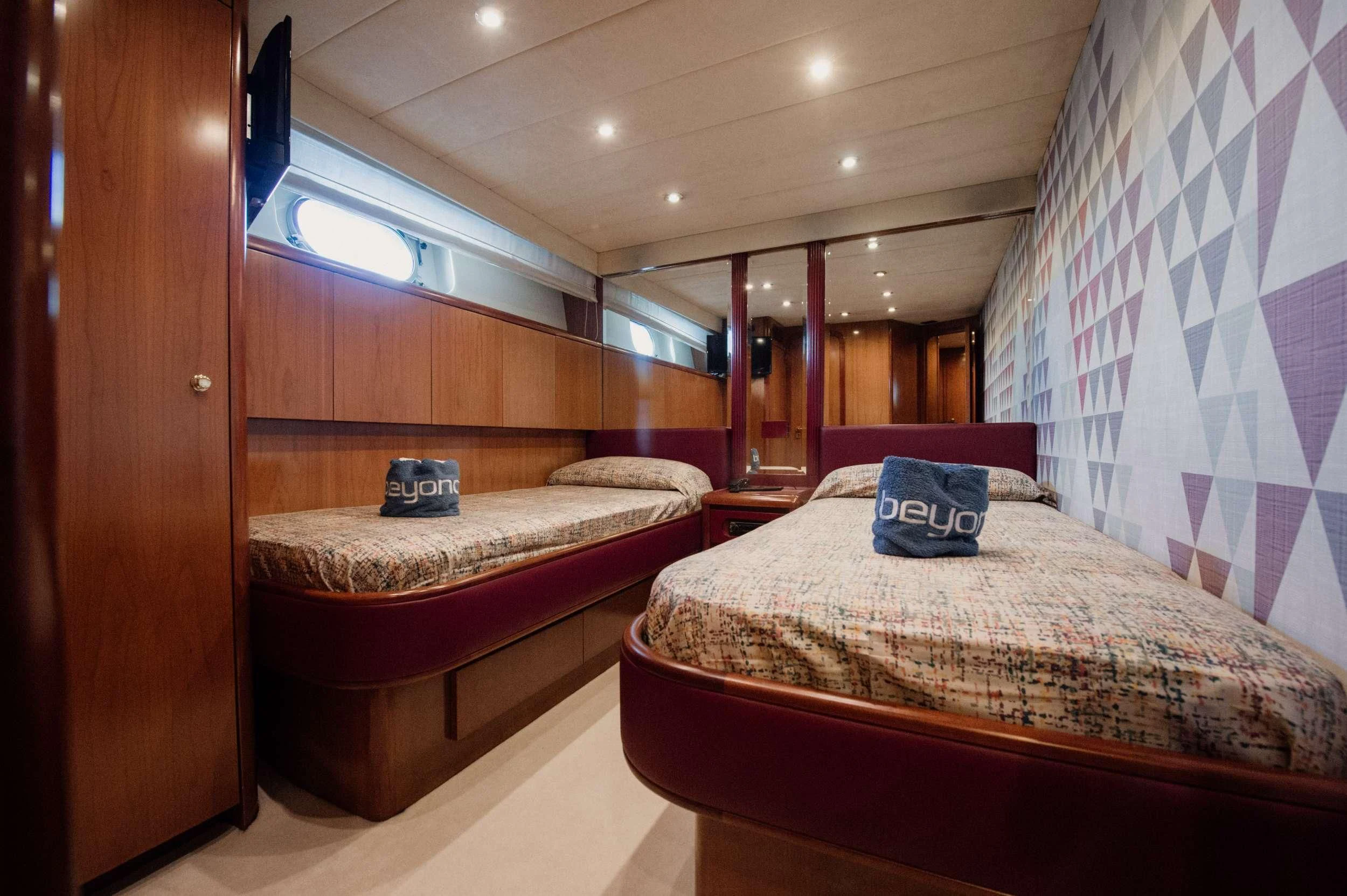 a couple of beds in a room aboard BEYOND Yacht for Charter