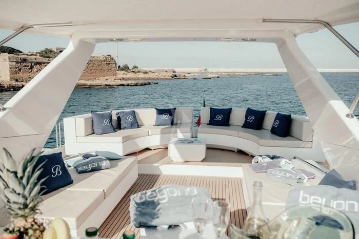 a room with a pool and a patio with a large white building aboard BEYOND Yacht for Charter