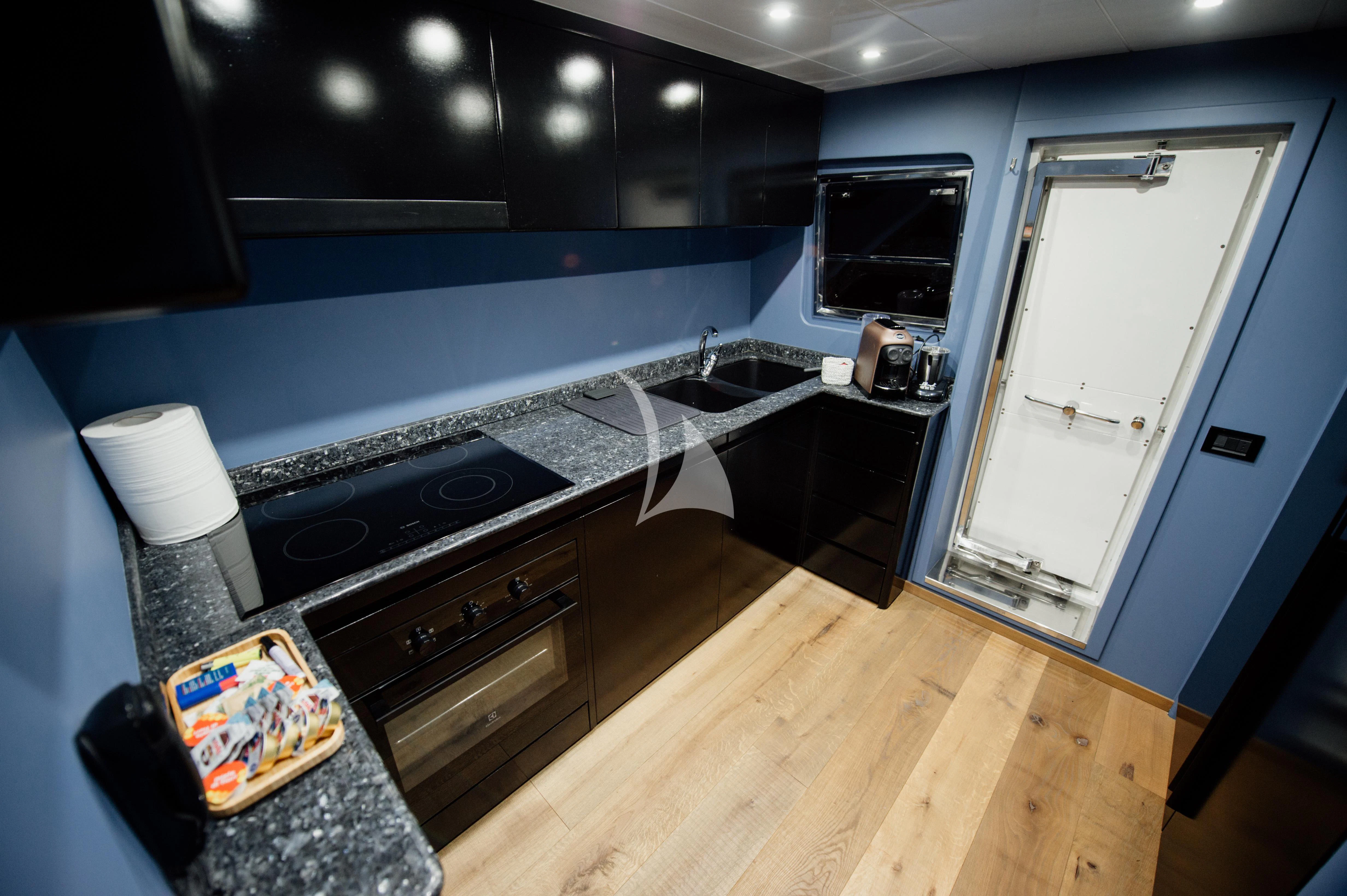 a kitchen with a wood floor aboard BEYOND Yacht for Charter