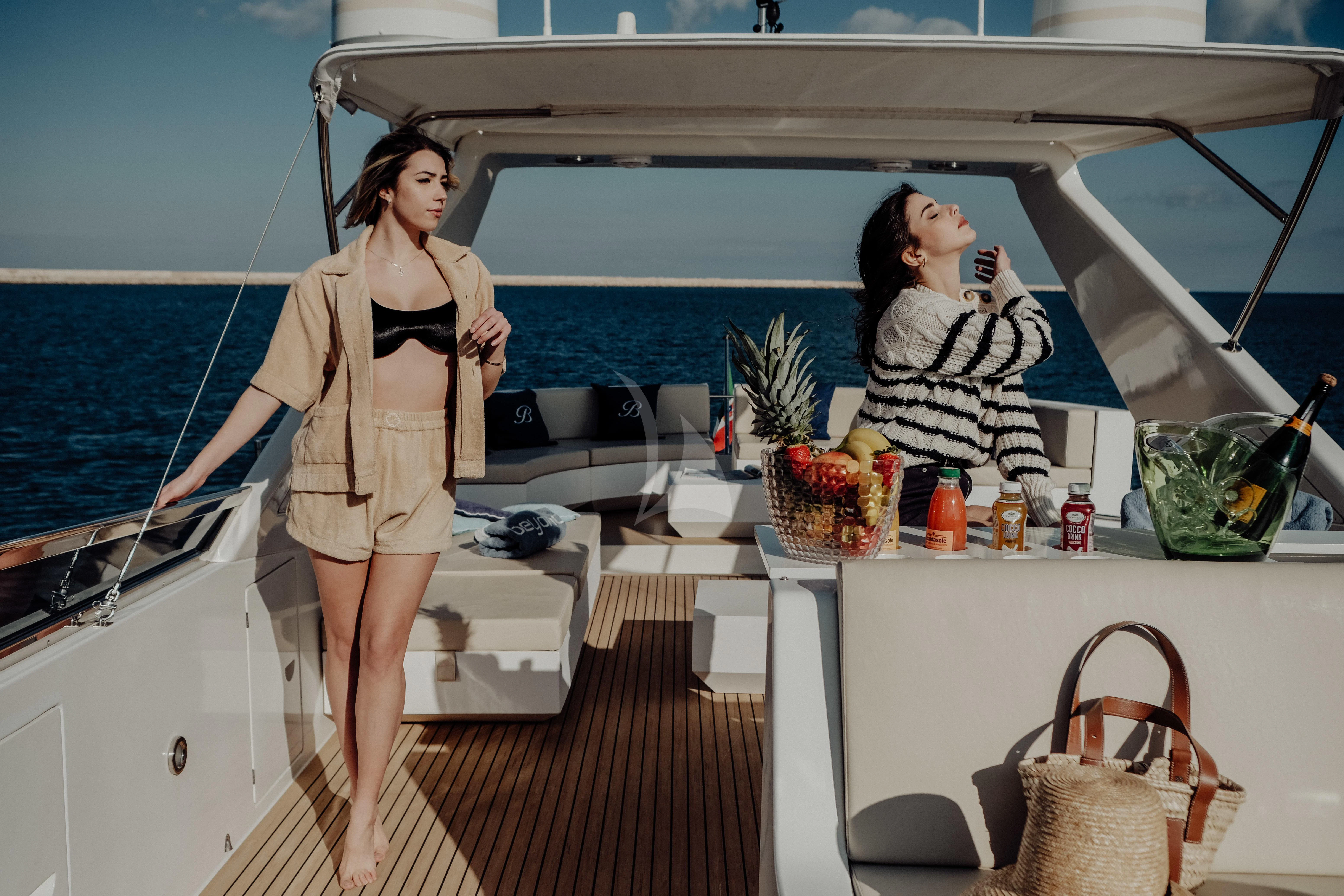 a woman standing on a boat aboard BEYOND Yacht for Charter