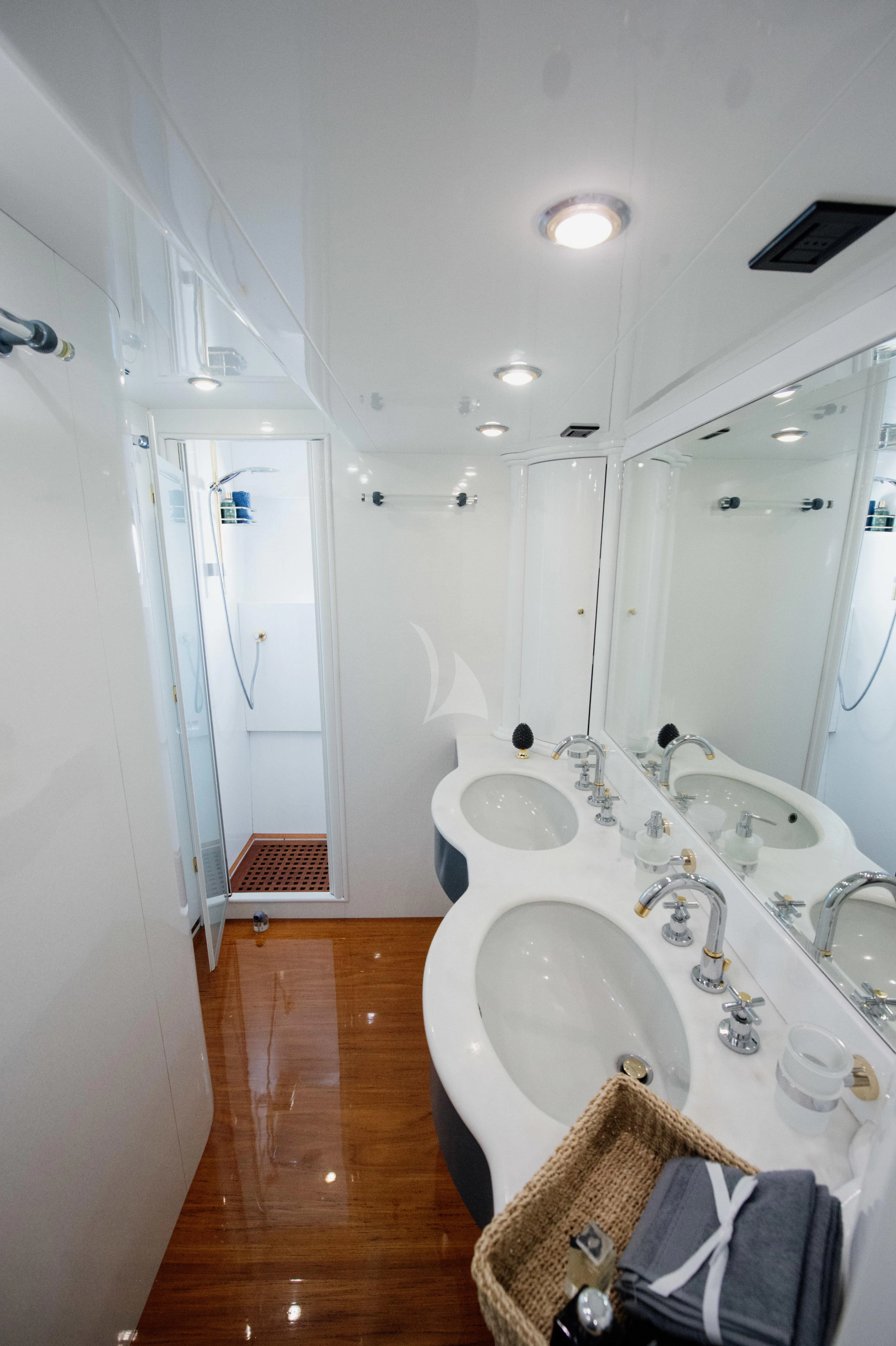 a bathroom with a tub sink and a wood floor aboard BEYOND Yacht for Charter