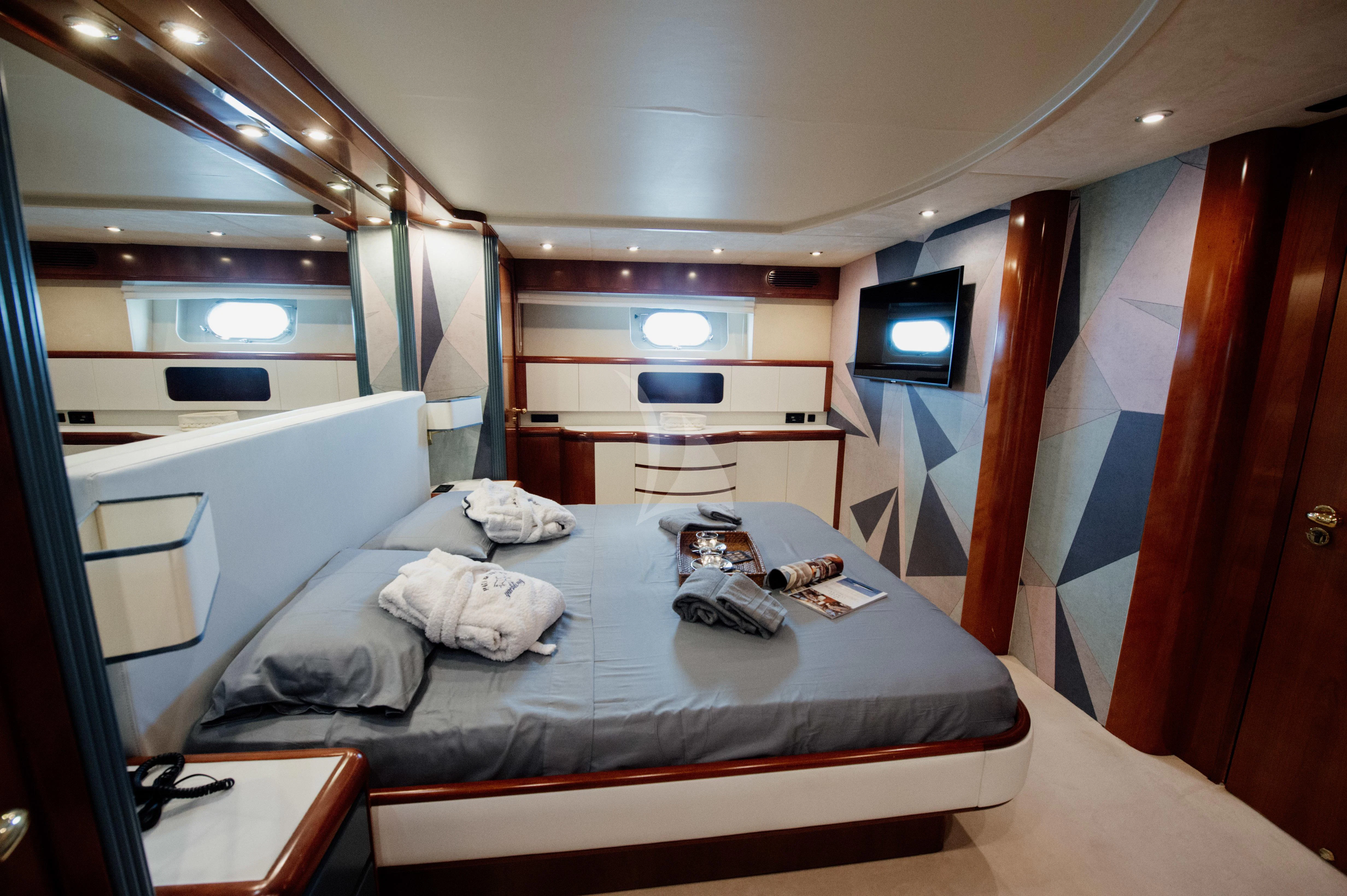 a room with a bed and a window aboard BEYOND Yacht for Charter